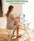 Woman using Solid Pick Portable Mini Sewing Machine For Beginners Featuring 12 Built In Stitches And Easy Hook Up Foot Pedal with fabric.