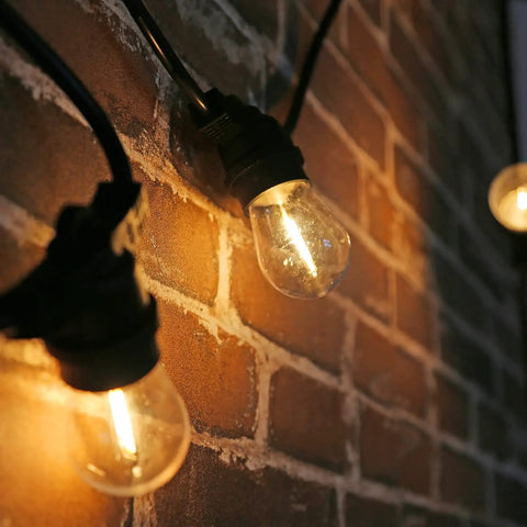 Shatterproof LED String Lights For Indoor Outdoor Use Waterproof And Weatherproof Cozy Warm White 2200K 70LM Output on brick wall