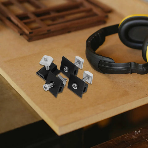 Premium 4 Piece Solar Panel Middle Clamps With M8 Bolts And Heavy Duty Pressure Blocks on wood surface with headphones.