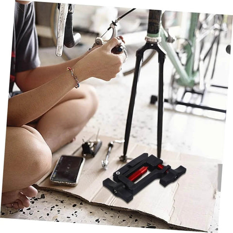 Hydraulic Hose Fitting Insert Tool For Bicycles With Needle Driver And Detachable Thimble Lock in use on a bike.