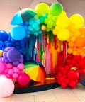 Top Shelf Fifty Piece Assorted Rainbow Five Inch Thick Durable Latex Balloons For Weddings Birthdays And Bashes Fresh Multicolor Party Decor That Brings Serious Good Times To Your Next Shindig in festive arch display with colorful umbrellas.