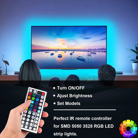 Person using RGB LED Light Strip Remote Controller Dimmer With Wireless IR 44 Keys for TV backlight effects