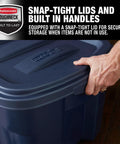 Heavy Duty 50 Gallon Stackable Plastic Storage Totes Two Pack With Secure Lids And Carry Handles Tough As Nails For Garage Junk Or Camping Gear Made In Usa hand securing lid on blue storage tote