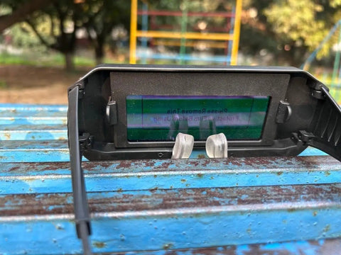 Kickass Auto Darkening Welding Glasses Solar Adjust Shade Control with clear lens showing adjustment features on table.
