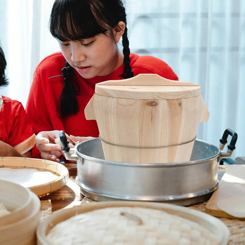 Handmade Wooden Rice Steamer Bucket With Flat Lid And Detachable Base For Commercial Kitchen Use placed on a steaming pot.