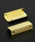 Premium Gold Cabinet Handles Finger Edge Pulls Sleek Brushed Finish two brushed gold drawer knobs on a black surface