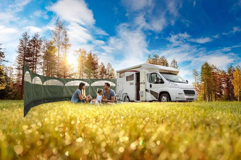 Family camping with Forest Green 5 Panel Wind Privacy Screen Windbreaker beside RV in grassy field, sunny day