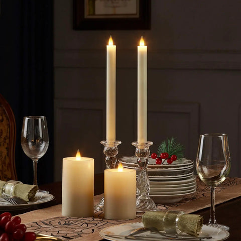 Two 9-inch ivory flameless taper candles with remote and timer realistic 3D moving flame on a dining table setting.