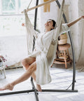 Heavy Duty Hammock Swing Stand With Solid Steel Construction, Easy Ten Minute Assembly, includes person enjoying swing