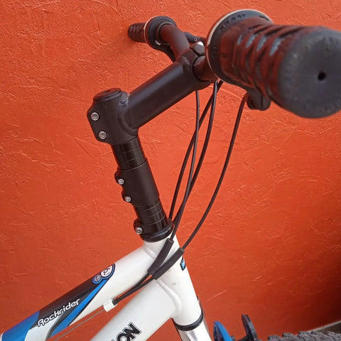 Close-up of bike with Bike Stem Riser And Handlebar Extender For MTB And BMX Aluminum Alloy Head Up Adapter installed.