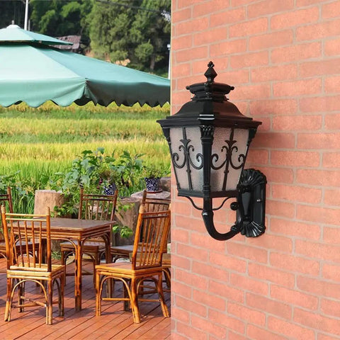 Hardcore Rustic Black Wall Lantern And Outdoor Wall Sconce With All Season Weather Proof Design For Front Porch Patio Entryway, mounted on a brick wall.