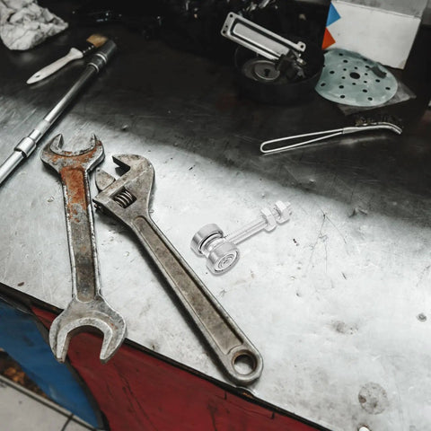 Heavy Duty Stainless Steel V Groove Sliding Door Pulley Wheel Featuring Dual Ball Bearings on a workbench with tools.