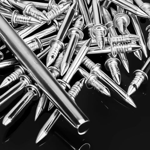 Pro Grade Double Head Skirting Nails Paired With Concealing Sleeve Inserts For Seamless Baseboard Trim close-up view of metal nails.