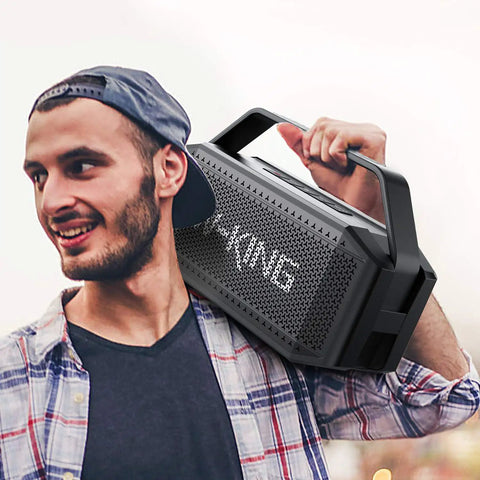 Man carrying Beast Bluetooth Speaker for Outdoors 100W Peak Power IPX6 Waterproof Boombox on his shoulder.