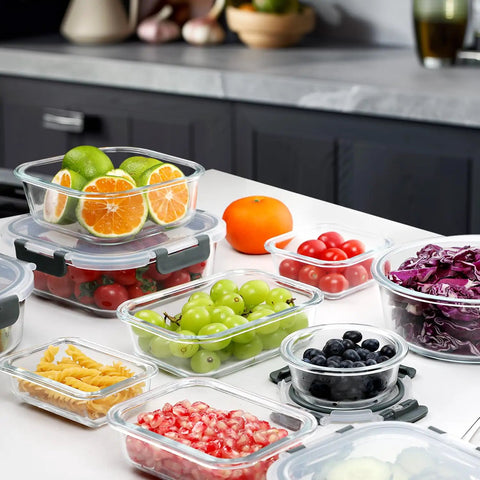 30 Piece Glass Meal Prep Containers Set With Stackable Lids, Airtight Glass Food Storage filled with fruits and vegetables in a kitchen.