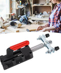 Double Headed Push Pull Quick Release Toggle Clamp with red plastic handle on cast iron base in woodworking shop.
