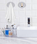Six Pack Peel And Stick Wall Hooks With Rock Solid Hold For Zero Hassle Bathroom Setup Self Adhesive Hangers For Towels Hats Coats And Everyday Carry holding a white towel in a modern bathroom setting.