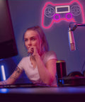 PS Controller Neon Light Sign For Gaming Rooms With Dimmer, LED Wall Decor in gaming setup with gamer under pink glow