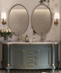 Stylish bathroom vanity featuring oval mirrors, gold accents, and elegant floral arrangement, perfect for modern decor.
