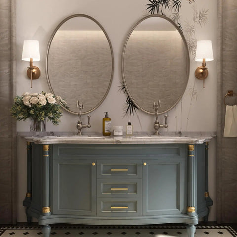 Stylish bathroom vanity featuring oval mirrors, gold accents, and elegant floral arrangement, perfect for modern decor.