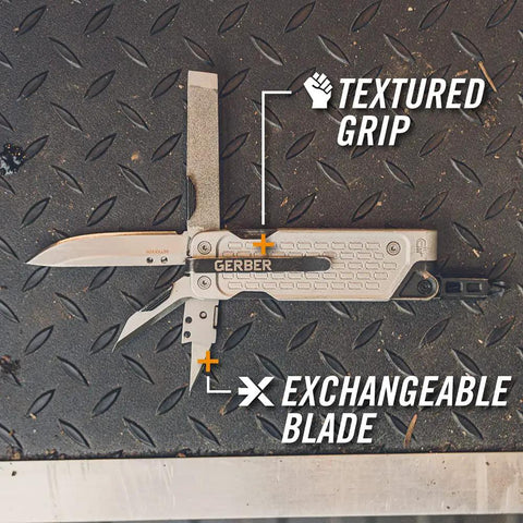 Lockdown Driver 7 In 1 EDC Multitool with 2.5 inch plain edge blade, textured grip, and exchangeable blade on metal surface