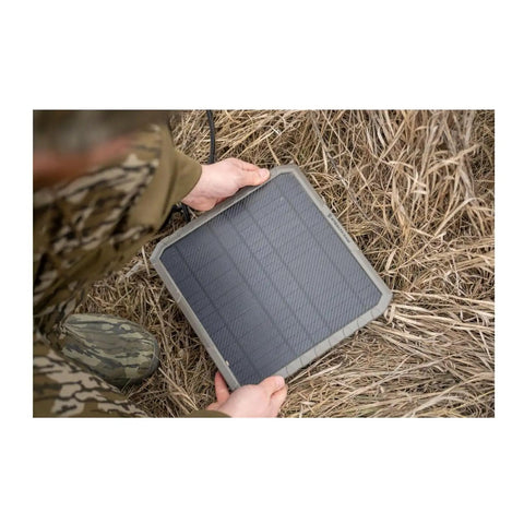 All Day Juice External 10 Inch Solar Panel With Integrated 10000 Mah Battery Pack For Trail Cameras on grassy ground.
