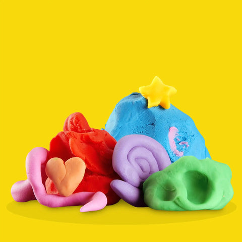 Colorful modeling clay creations in various shapes on a yellow background, part of Game Changing Modeling Compound Haul With 65 Mini Cans Serving Up Sixty Varieties Including Rainbow Classics Plus Sparkle Confetti and Color Burst Vibes Ideal for Back to School Supply Lists and Preschool Projects for Kids Two Plus.
