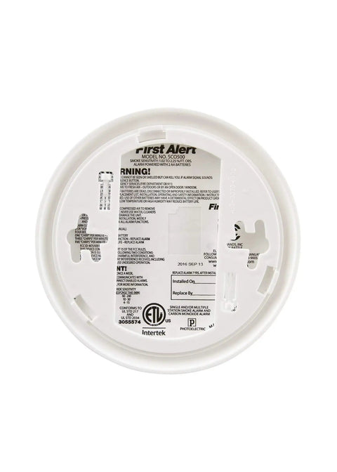 Bottom view of Battery Powered SCO500B Wireless Interconnected Smoke and CO Alarm showing label and mounting bracket details.
