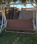 Outdoor 3-seater swing with brown cover on frame, illustrating replacement use for Heavy Duty 600D Patio Swing Seat Cover.