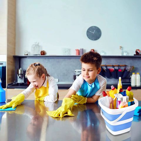 Two children cleaning a kitchen counter with a 2 Pack Collapsible Buckets 5L 1.3 Gallon Portable Cleaning Bins nearby