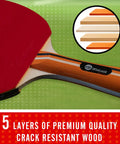 Close-up of a paddle from the Four Paddle Ping Pong Set With Carry Case And Eight Balls showing 5 layers of crack-resistant wood.