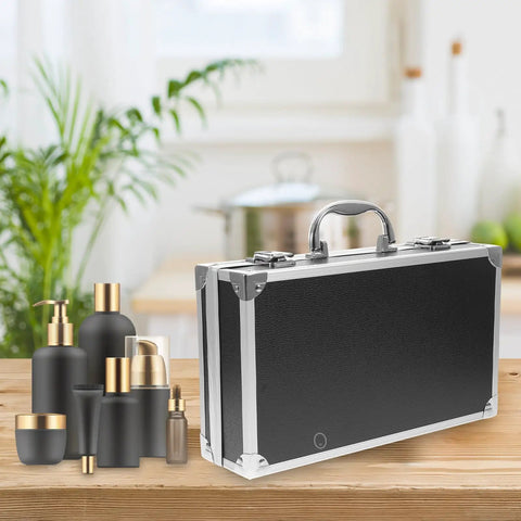 Kickass Aluminum Toolbox Carrying Case With Grip Handle Top Shelf Rigid Shell Organizer Hella Tough Storage Solution For Camera Gear Medicines Tools And Office Stationery Essentials on a wooden table next to cosmetic bottles.