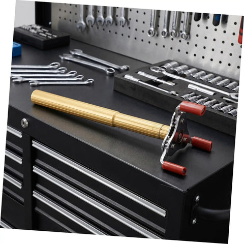 Dead Simple Fire Alarm Removal Tool With Long Extendable Pole on a workbench among tools, featuring rugged grip and golden finish.