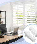 100 Count White Spring Loaded Shutter Pins Quick Snap Hardware For Plantation Window Shades with desk and window background.