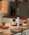 Rechargeable USB C Milk Frother With Stand, Handheld Wand With 3 Heads And 3 Speeds For Latte Cappuccino Matcha Almond Milk And More, Easy To Clean, Barista Quality At Home on kitchen counter with coffee cups