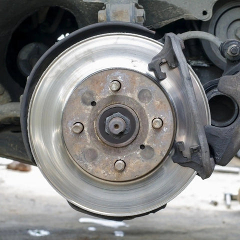 Car brake rotor and caliper illustrating the need for internal tooth lock washers and push on fastening clips kit for industrial fastening