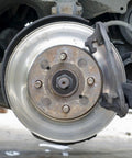 Close-up of a car brake disc and caliper, suitable for use with Internal Tooth Lock Washers Push On Clips Fasteners Assortment Kit.