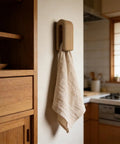 Premium Wall Mount Automatic Locking Towel Hook With Smart Space Saving Design And No Sweat Storage For Daily Grind In Slick Matte Black Finish For Any Modern Setup with a towel.