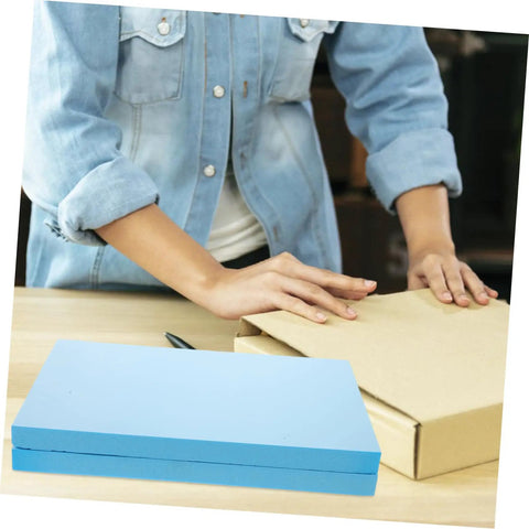 Premium Polyurethane Foam Sheet Cuts For Toolboxes And Cases Delivering Kick Ass Protection For Sensitive Gear During Road Trips And Moves With Heavy Duty Cushioning That Keeps Everything Locked Safe And Secure, with blue foam above a cardboard box.