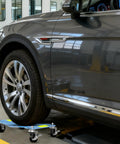 Heavy Duty Car Dolly Set of 4 with 6000 Lbs Per Unit Capacity used under car wheel for easy movement in workshop.