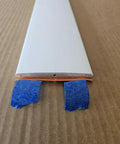 Solid Hardwood Shutter Louver Replacement Kit Five Pack, extra white painted louver with blue tape on edges to secure during installation.