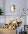Dope 360 Degree Adjustable Moon Pendant Light With Rotating Sphere Shade above dining table in modern living space