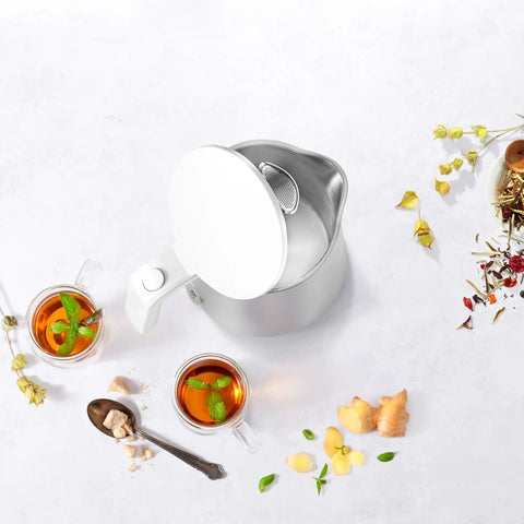Top view of Cool Touch 1 Liter Cordless Electric Kettle With Double Wall Stainless Steel and tea cups on a light surface