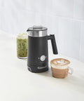 Black hot and cold foam milk frother for coffee and cafe style drinks like lattes cappuccinos macchiatos and hot chocolate with stainless steel nonstick milk tank.