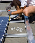 Installation of Rock Solid Heavy Duty Aluminum Solar Panel Clamps 12 Piece Set on rooftop with M8x25 hex screws.
