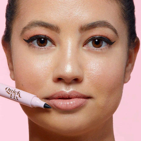 Close-up of a model holding a Reusable Waterproof Makeup Remover Pen for quick lipstick fixes with a fine tip.