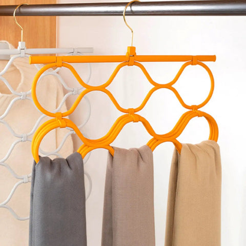 Foldable Scarf Organizer Rack With 18 Slots For Closet Storage And Necktie Display Durable Space Saving Accessory Hanger hanging with grey, beige, and brown scarves.