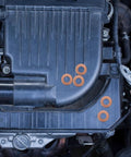 Copper Crush Sealing Washers Kit 200 Pieces Flat Ring Gaskets visible on an engine for automotive plug repair.