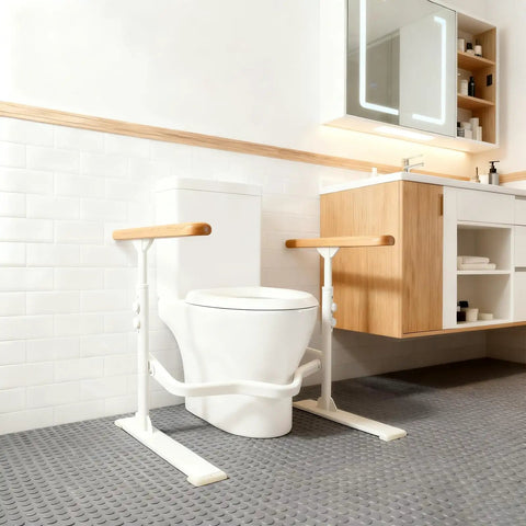 Heavy Duty Toilet Safety Rails For Seniors With Nighttime Reflective Armrests And Base No Fuss Height Adjustments Bulletproof Bathroom Support Bar Fits Standard Toilets Wood Trim next to a toilet.