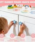 Child using Totally Adorable Goofy Cartoon Drawer Knobs For Kids Room 6 Pack Ultra Soft Rubber Pull Handles on white dresser.